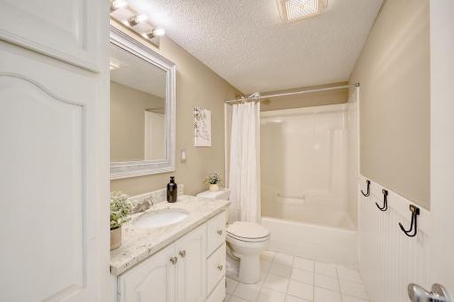 Lower level full bath with tile floor and granite vanity top