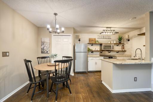 Granite kitchen countertops and breakfast bar flow seamlessly into the dining and entertaining areas.