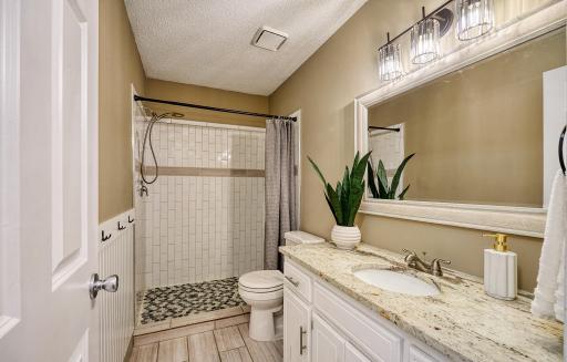 Main floor bath, Granite vanity top & tiled step-in shower.