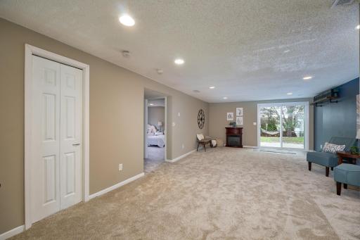 Family room with new carpet, fresh paint, & recessed lighting