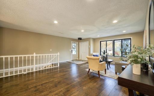 Open floor plan, sun-filled spaces, warm wood flooring, and fresh paint make this a home both a haven and a great place to entertain.