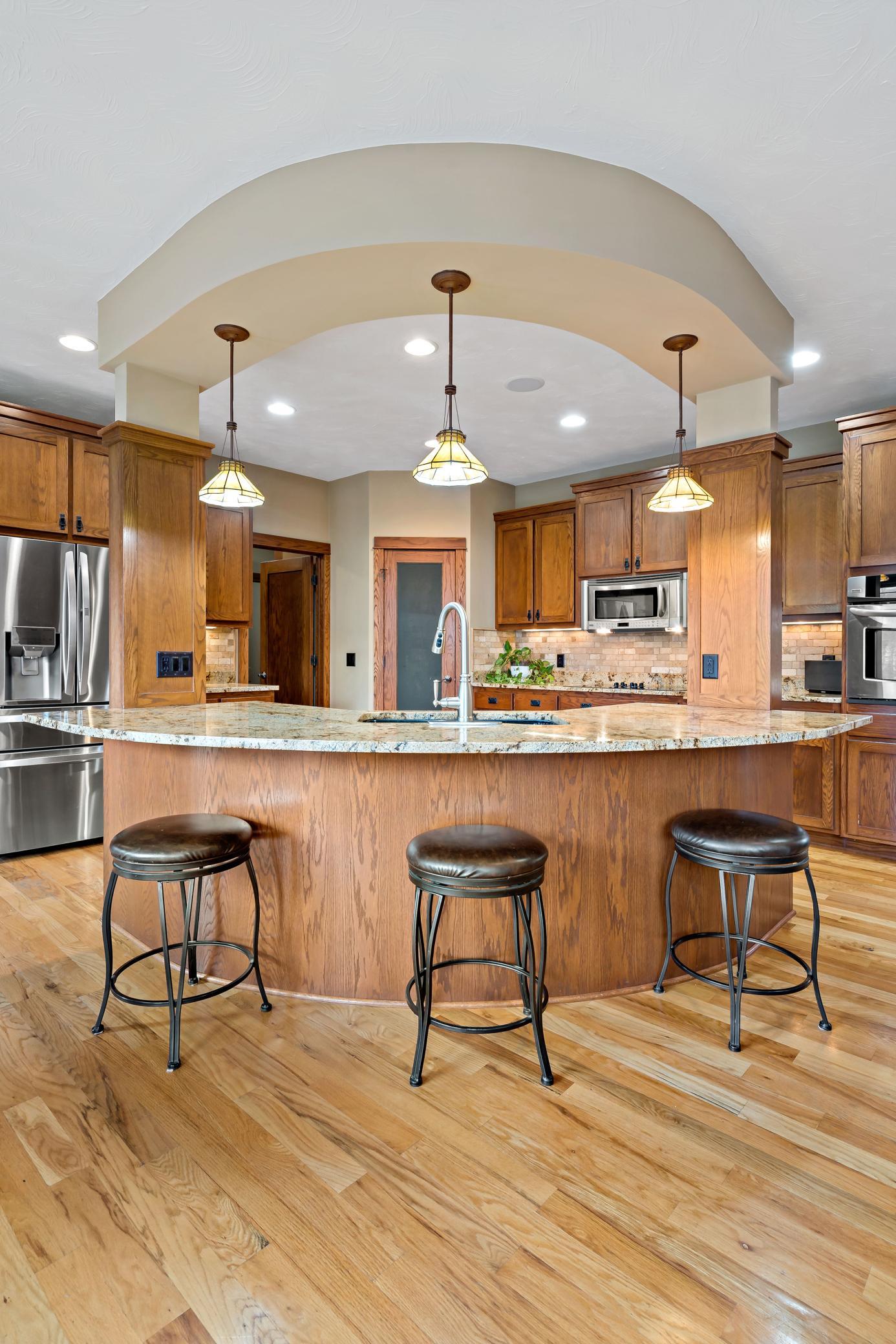Architectural details that set this home apart from the rest include this round center island. It is a show stopper, but also very convenient for every day living and entertaining.