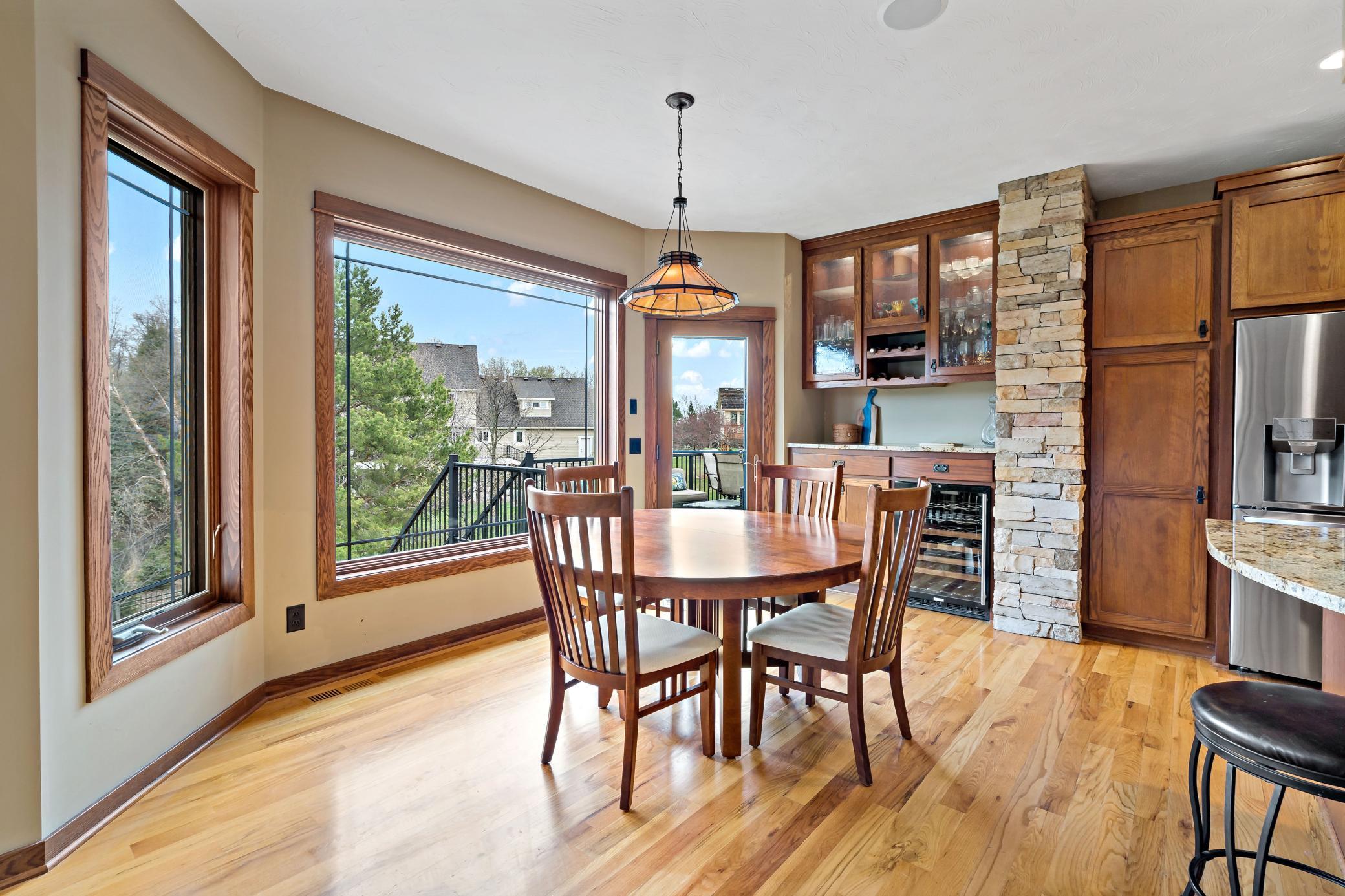 Look Closely! Behind the dining table is a custom built-in hutch offering a wine rack, wine cooler, abundant storage, and stunning glass cabinet doors with interior lighting.