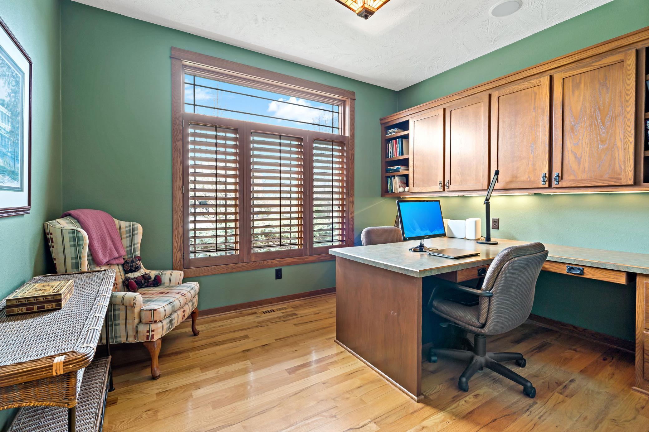 Dedicated office on the main level offers a workspace for two and loads of built in storage.