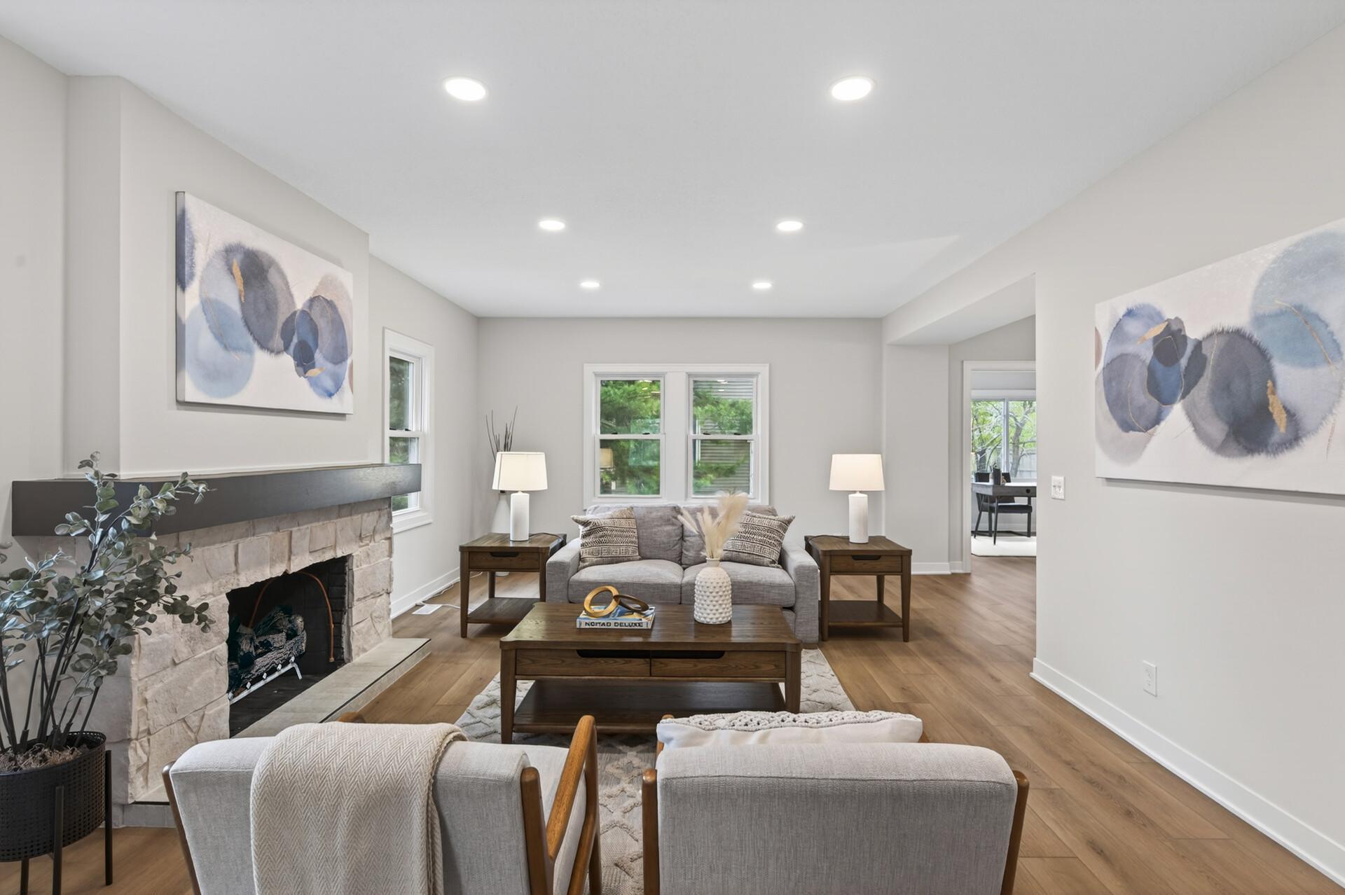 Anchored by new LVP flooring and a beautifully redone non-functioning fireplace with a classic mantel that creates a warm focal point (with the option to add a gas insert).
