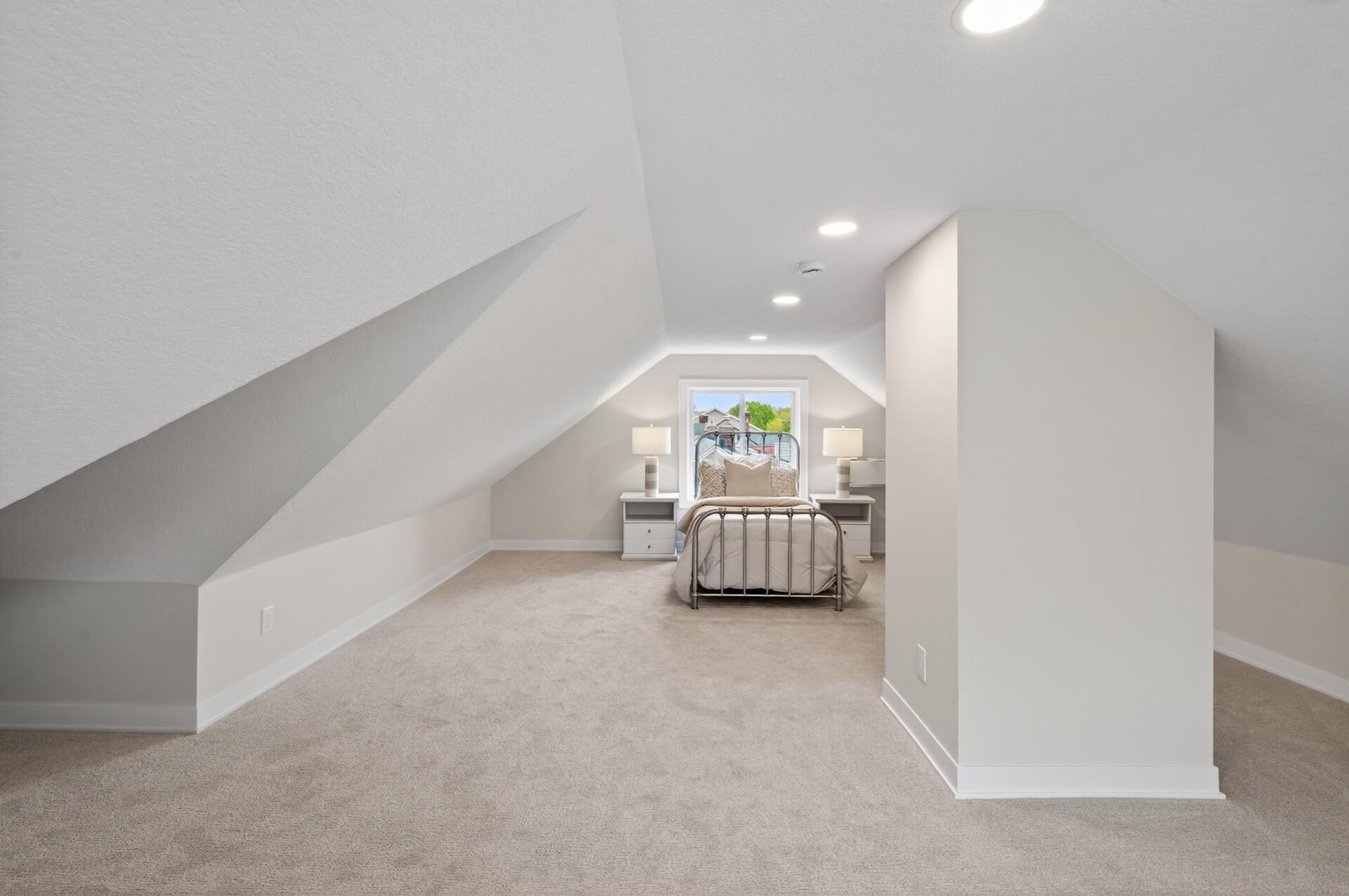 The newly finished loft level adds incredible versatility, whether used as an additional bedroom, media room, or creative space.