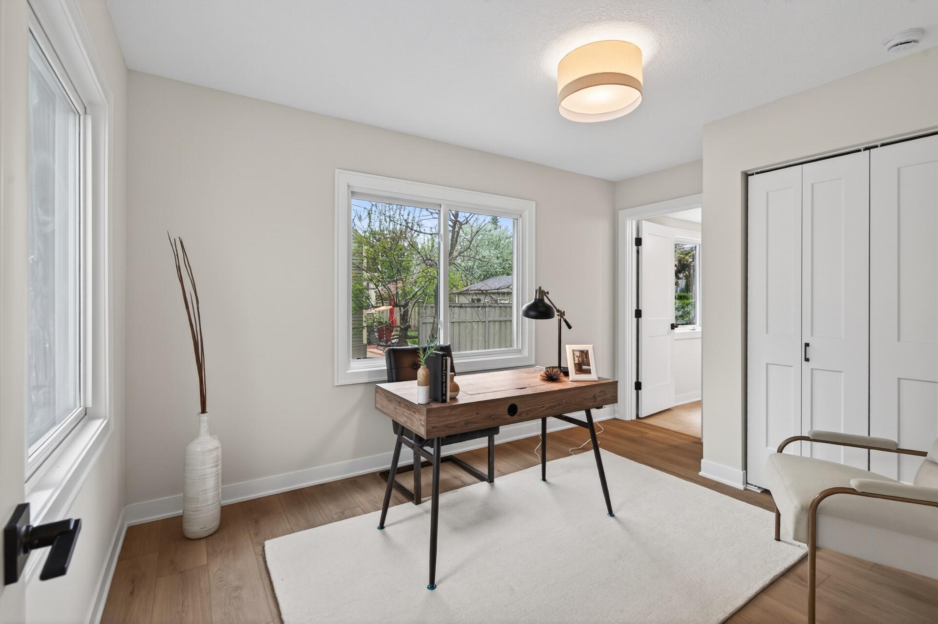 A spacious main-level addition adds flexibility with a bedroom and private ensuite, ideal for guests, primary, or office if desired.