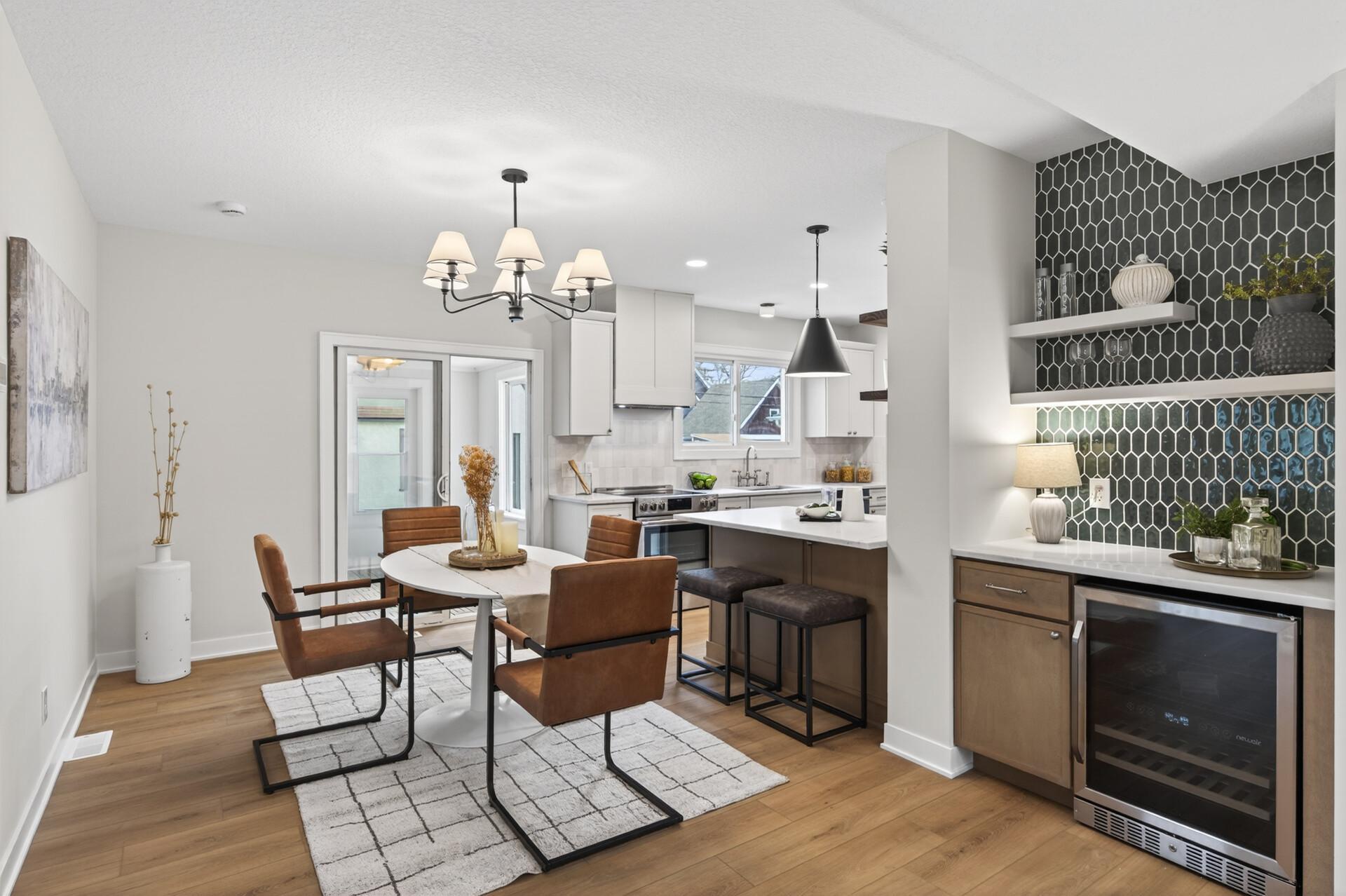 The kitchen flows seamlessly into the dining space, highlighted by updated statement lighting and continuous LVP flooring, creating an easy, connected layout for gatherings or everyday living.