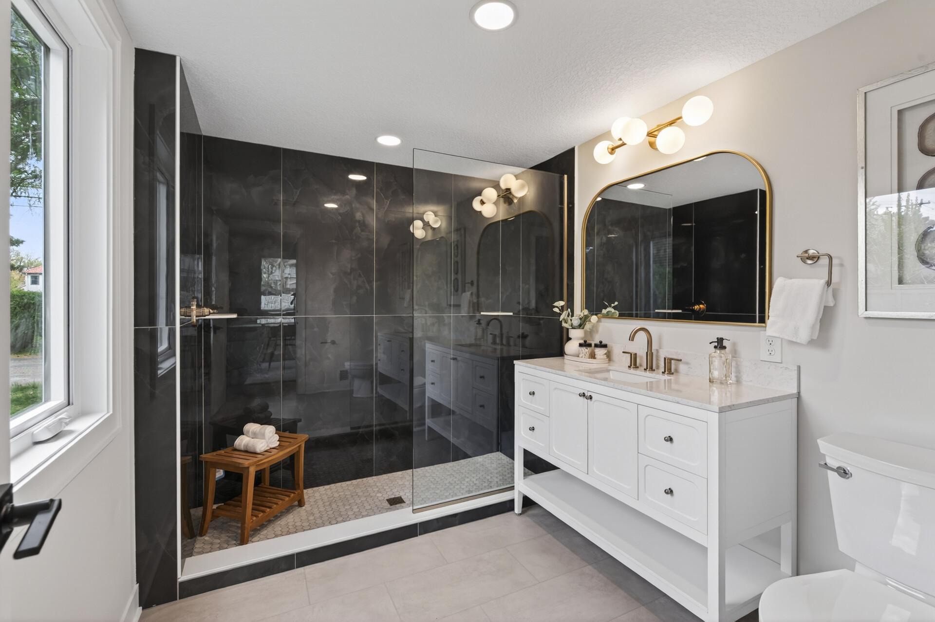 The bathroom features a large, beautifully tiled walk-in shower for a spa-like feel.