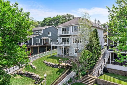 Stairs lead down to a sandy beach & dock on Prior Lake!