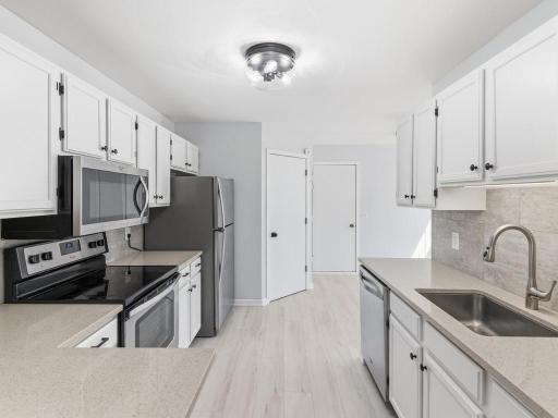 Bright, functional Kitchen has stainless steel appliances and under-mount sink..