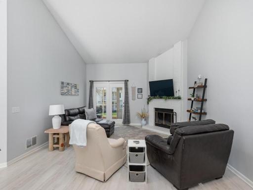 Vaulted Living Room has striking woodburning fireplace focal point.