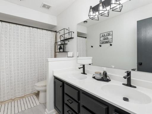 The stylish Primary Bath has tile floor and a dual sink vanity.