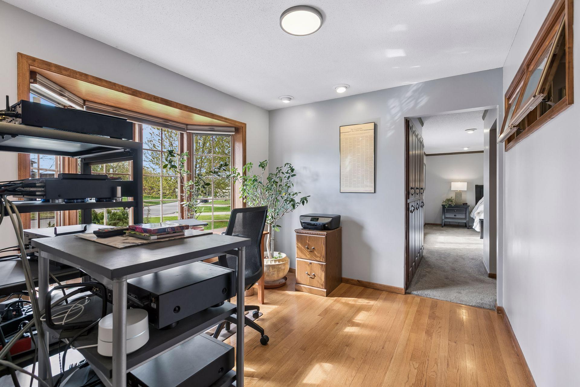 Sunny bay window and hardwood floors create a cheerful work space!