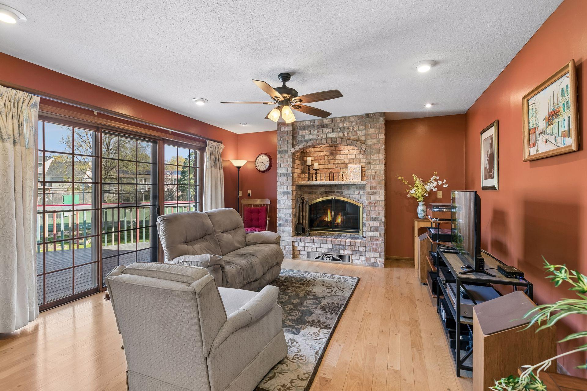 Just one of three wood burning fireplaces in this warm and welcoming area which also walks out to a deck