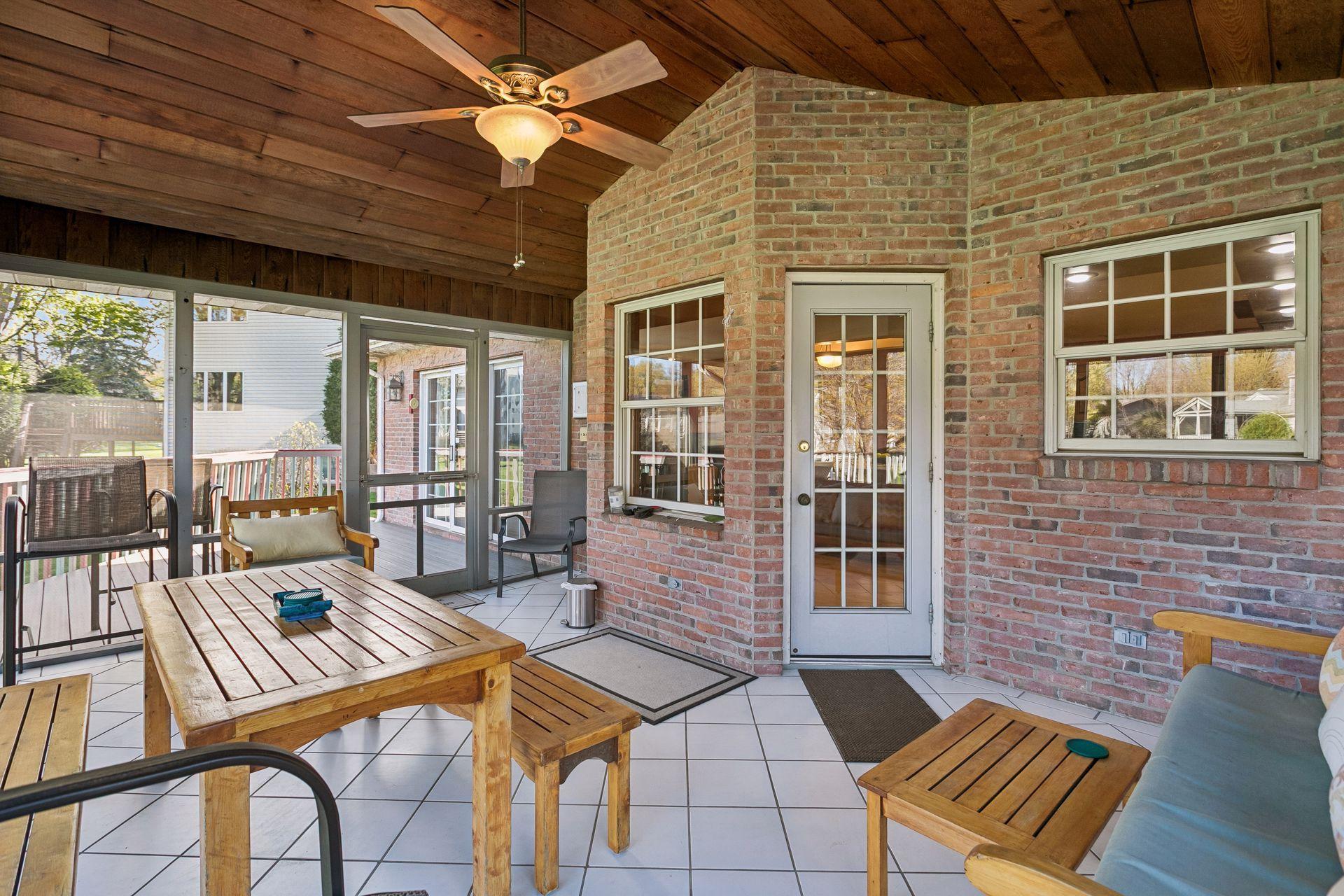 Screened porch has two entrances out to two separate decks