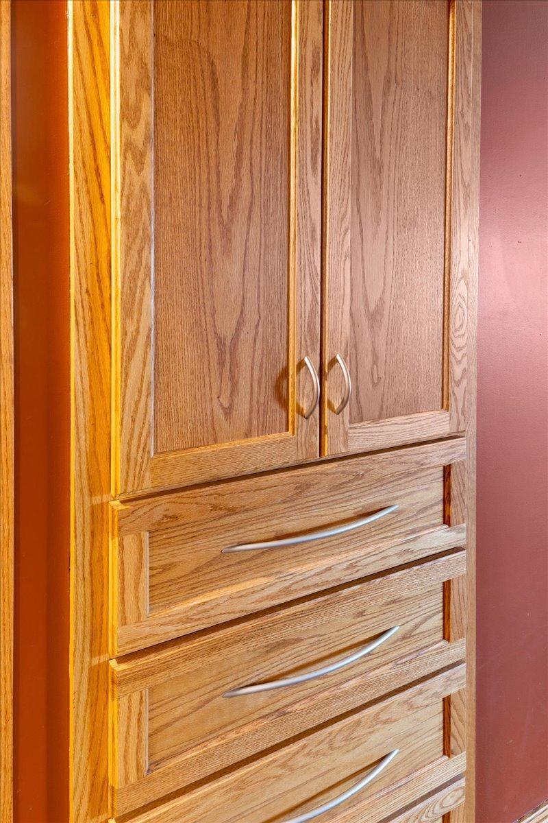 Built-in Linen in upper level hall with cabinets and drawers