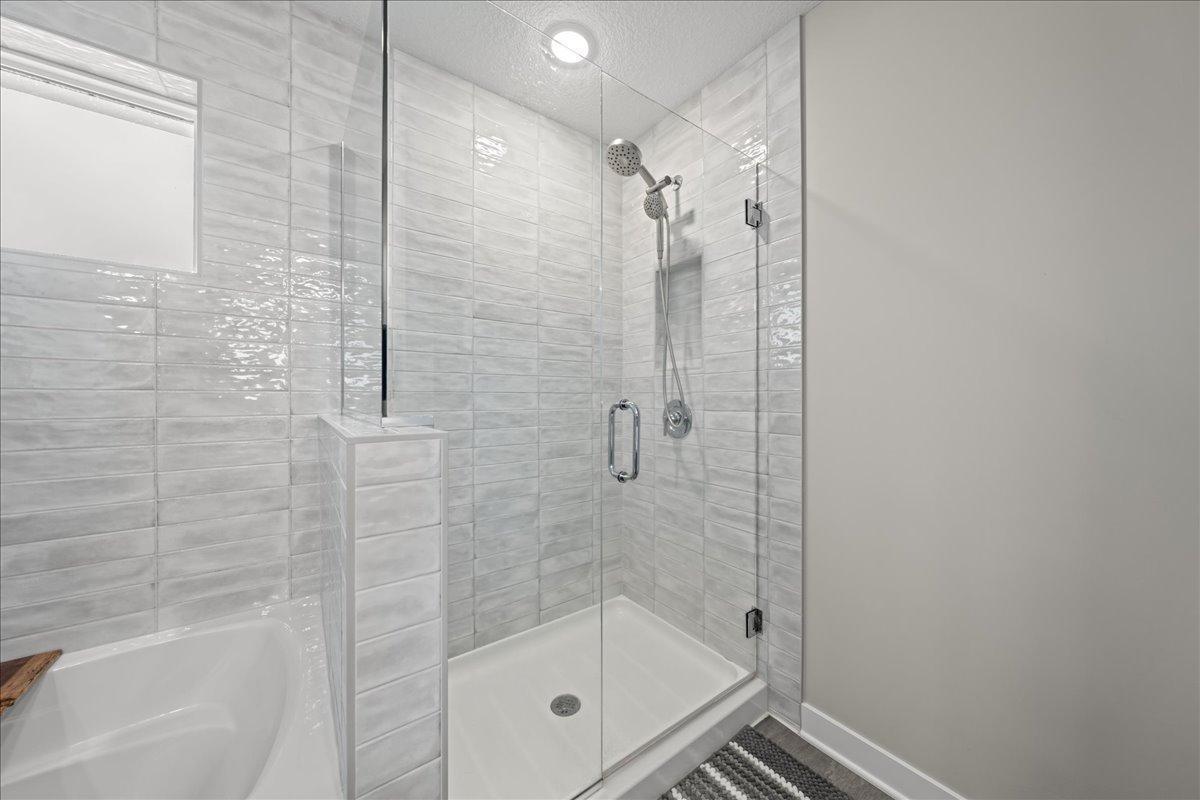 Owners shower tiled to ceiling shower