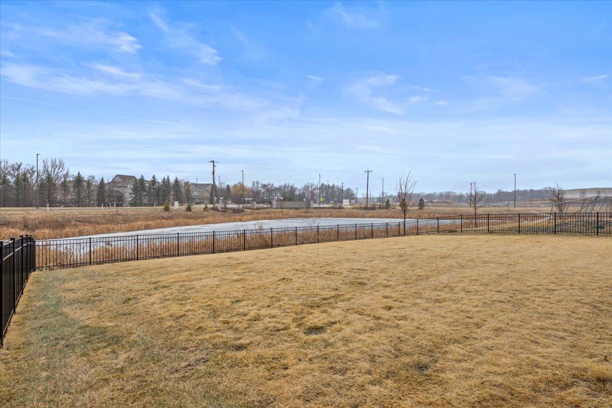 Fenced backyard that backs up to a pond