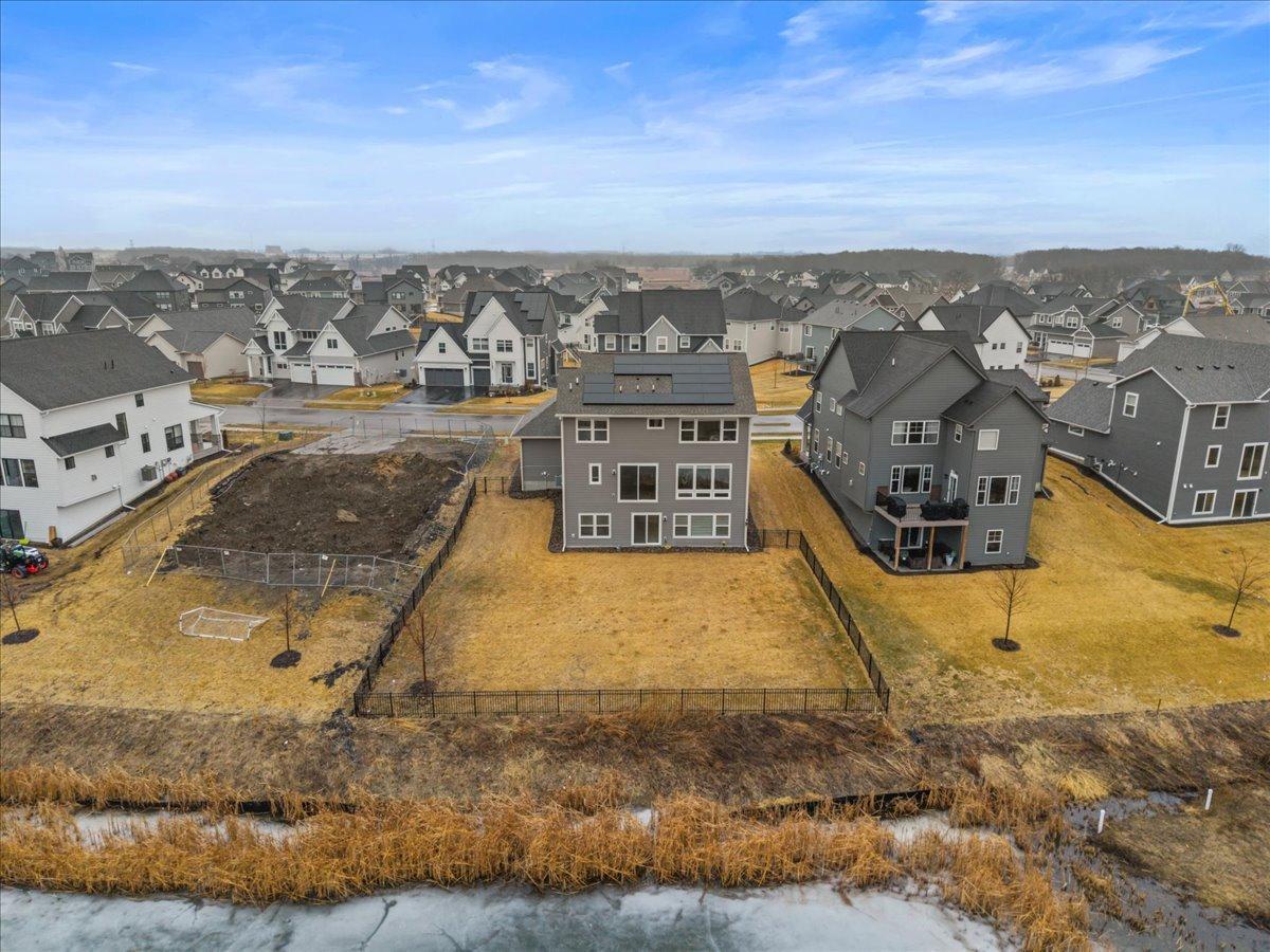 Fenced backyard next to pond