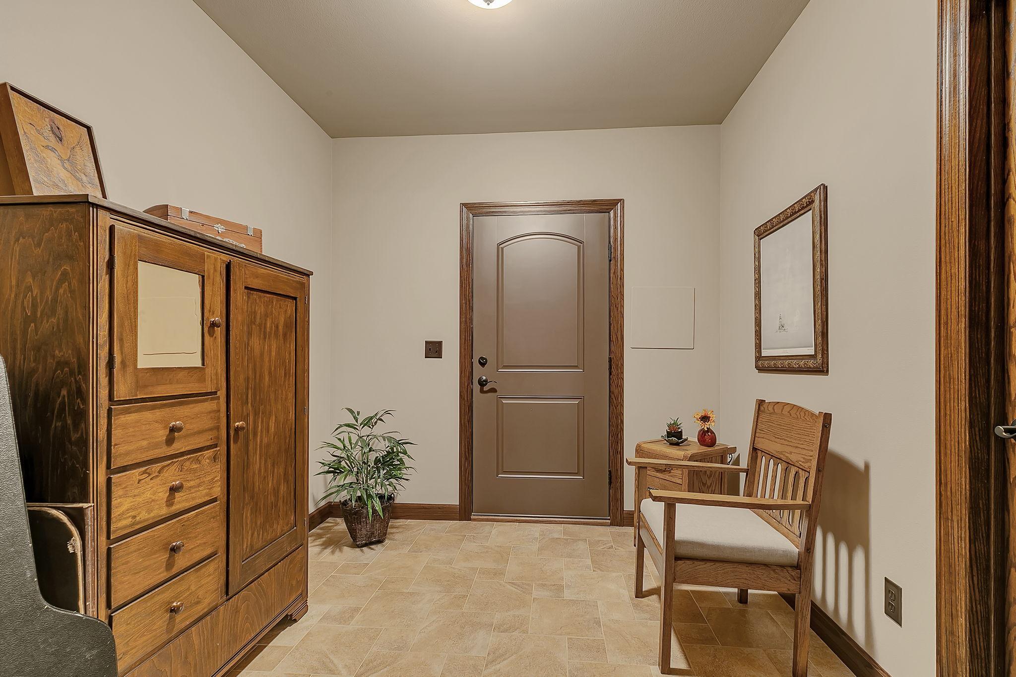 Lower mudroom entrance with access to stairs leading up to the finished garage with in-floor heat