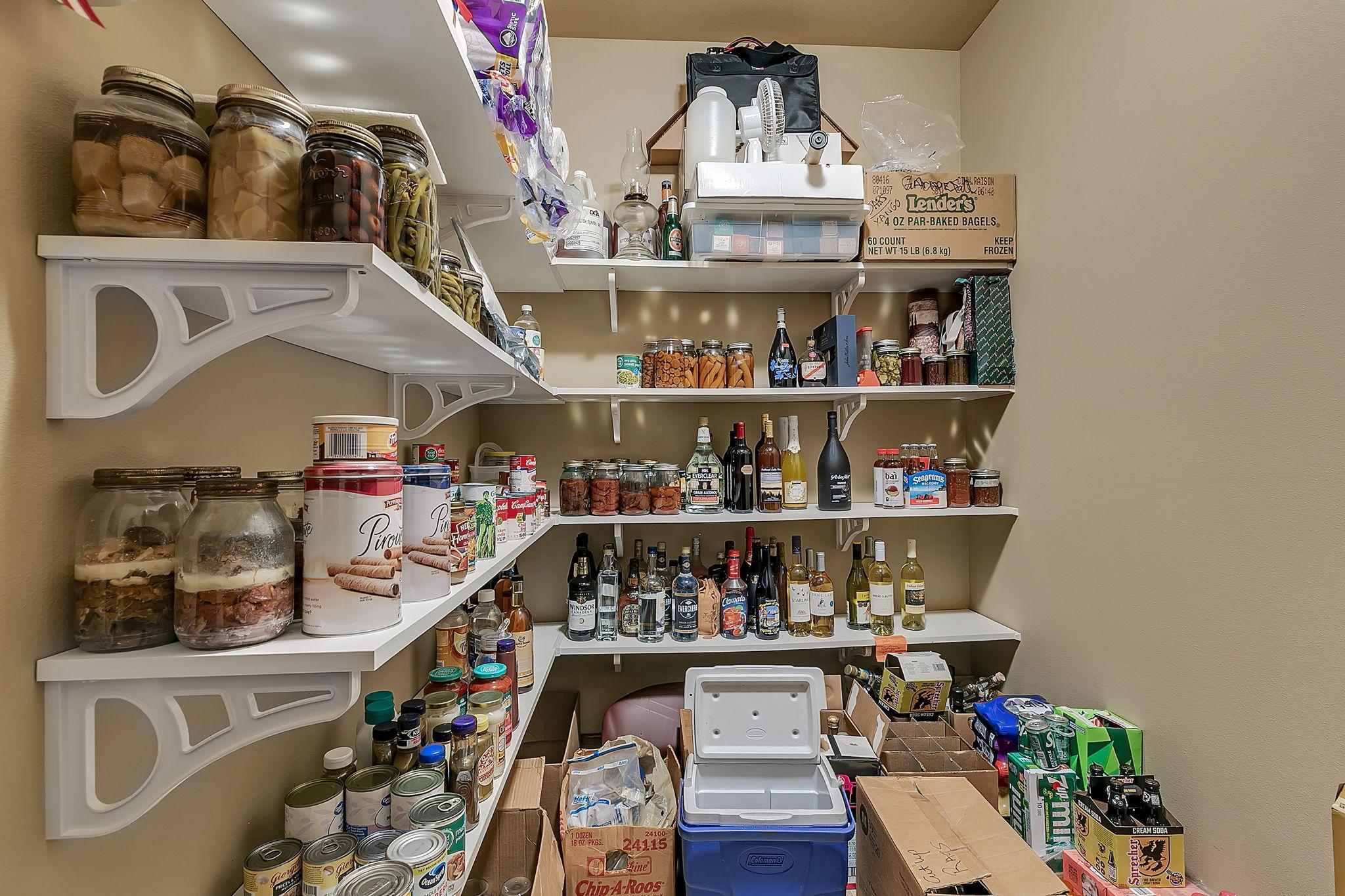 Additional pantry space in the lower level off the garage access which could make a great wine cellar next to the bar