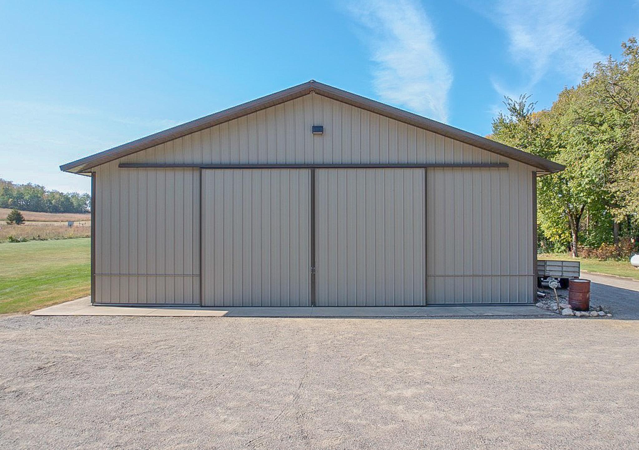 Rear of shed features 24' wide X 15' high sliding door