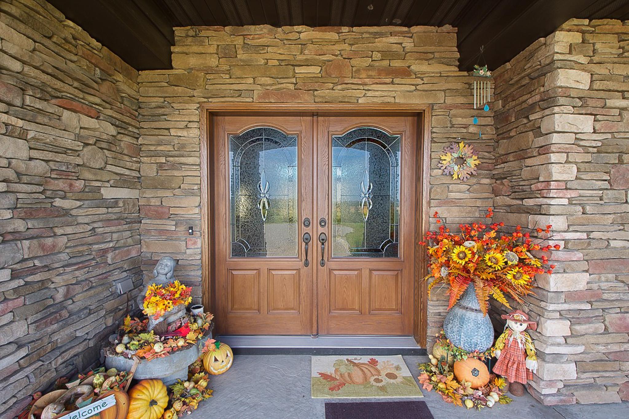 Inviting double doors leads you into this custom built home