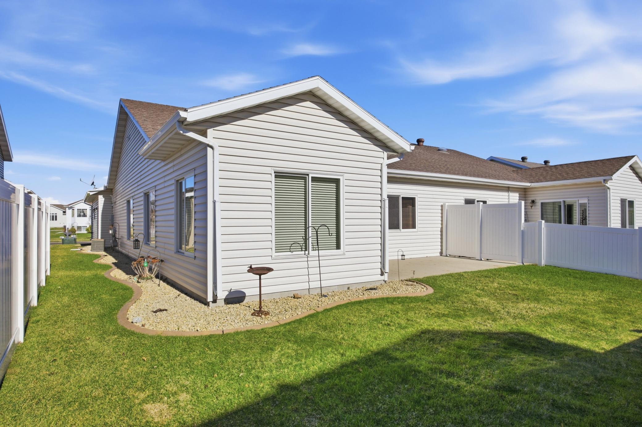Rear Exterior - Concrete curb edging and low-maintenance landscaping