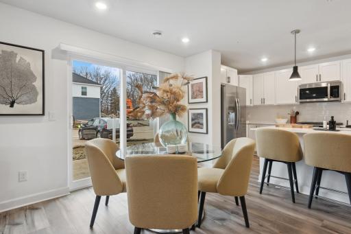 (Photo of decorated model, actual home's finishes vary) Soaked in natural sunlight, the homes eat-in dining room has ample space for a dining table located in the heart of the home.