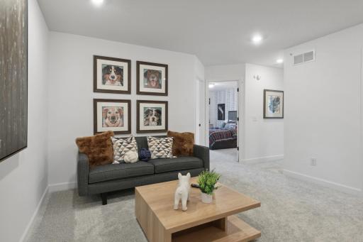 (Photo of decorated model, actual home's finishes vary) Located on the upper level, this perfectly sized living space has enough room for a desk, television and seating for all. Plus, it is just steps away from the three bedrooms.