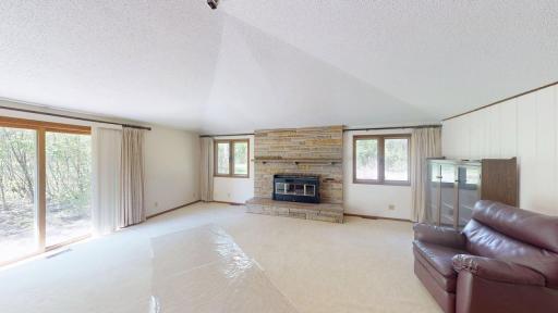 Spacious family room w/wood burning fireplace and walkout to the yard