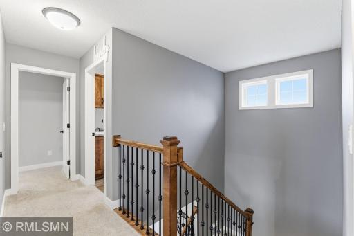 Upper-level landing offers a functional layout with easy access to bedrooms and bathrooms. Bright and open with natural light, creating a comfortable transition between living spaces.