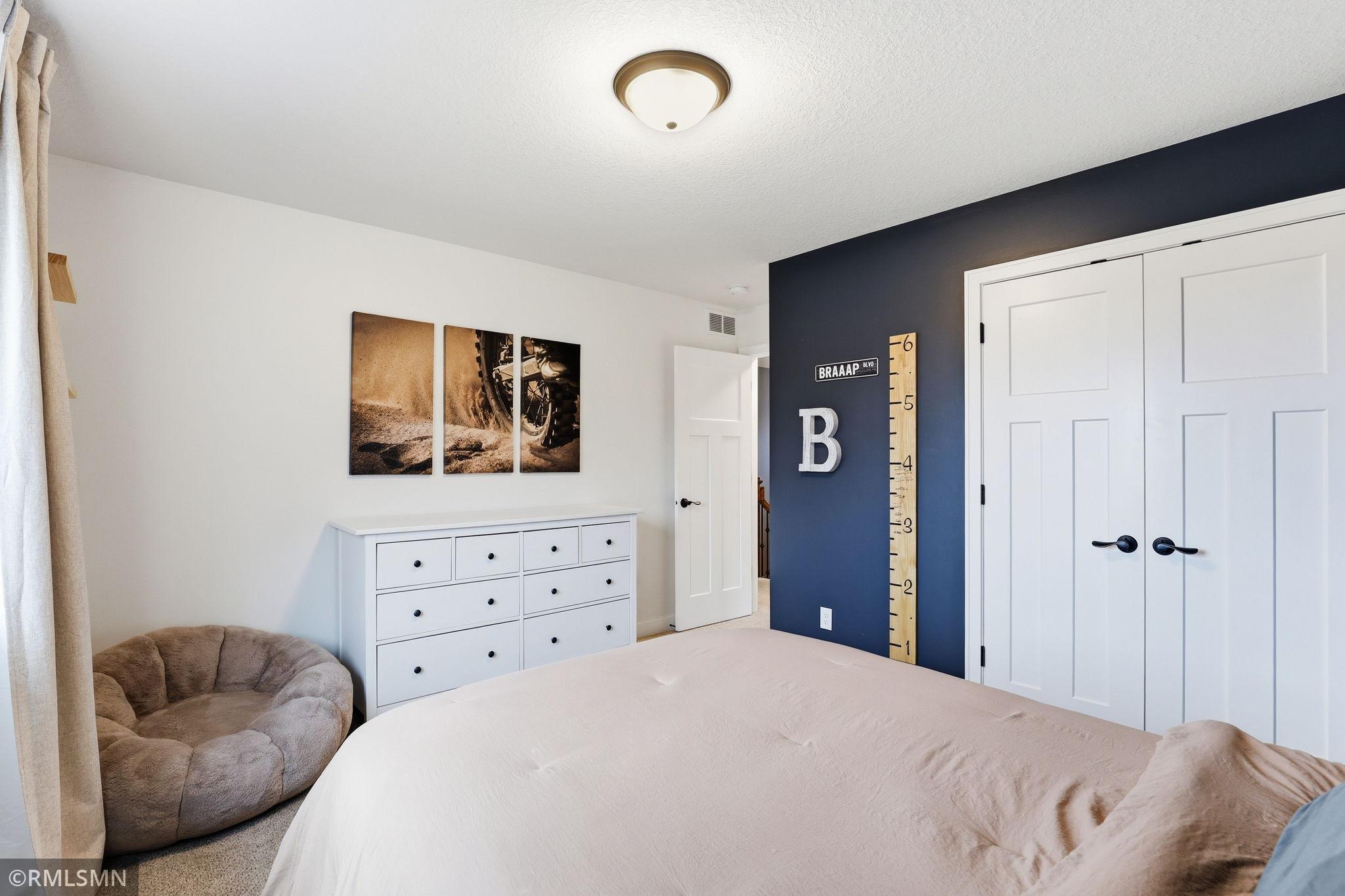 Sprawl out in this upper level bedroom featuring generous space, warm tones, and a calming atmosphere that makes it easy to relax and unwind.