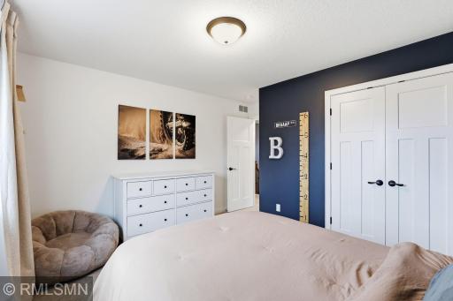 Sprawl out in this upper level bedroom featuring generous space, warm tones, and a calming atmosphere that makes it easy to relax and unwind.