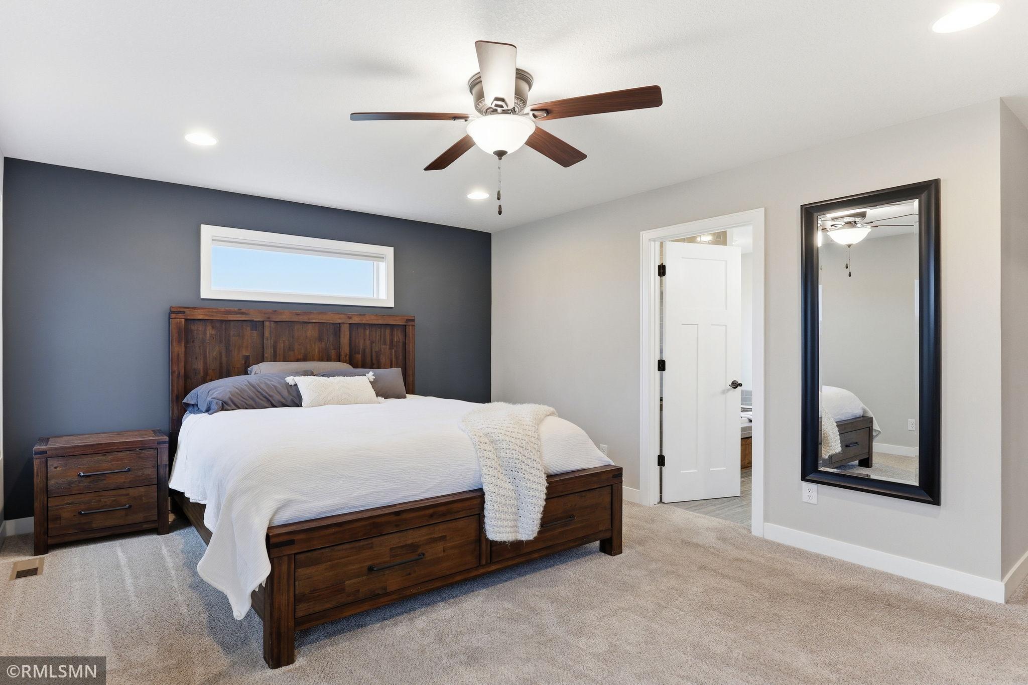 Relax in the private primary suite with a stylish accent wall and easy access to the ensuite bathroom and walk-in closet. Start and end your day in a quiet space designed for comfort and convenience.