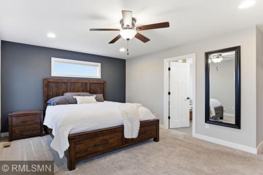Relax in the private primary suite with a stylish accent wall and easy access to the ensuite bathroom and walk-in closet. Start and end your day in a quiet space designed for comfort and convenience.