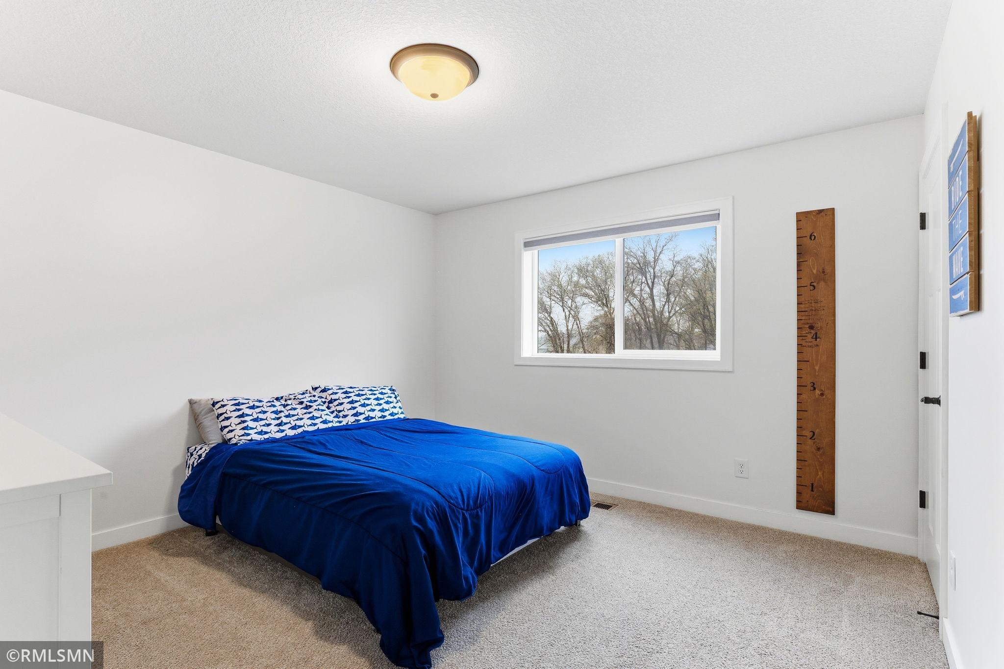 Rest and recharge in this bright upper-level bedroom with soft carpet and natural light. Set up your space, unwind comfortably, and enjoy a peaceful retreat.
