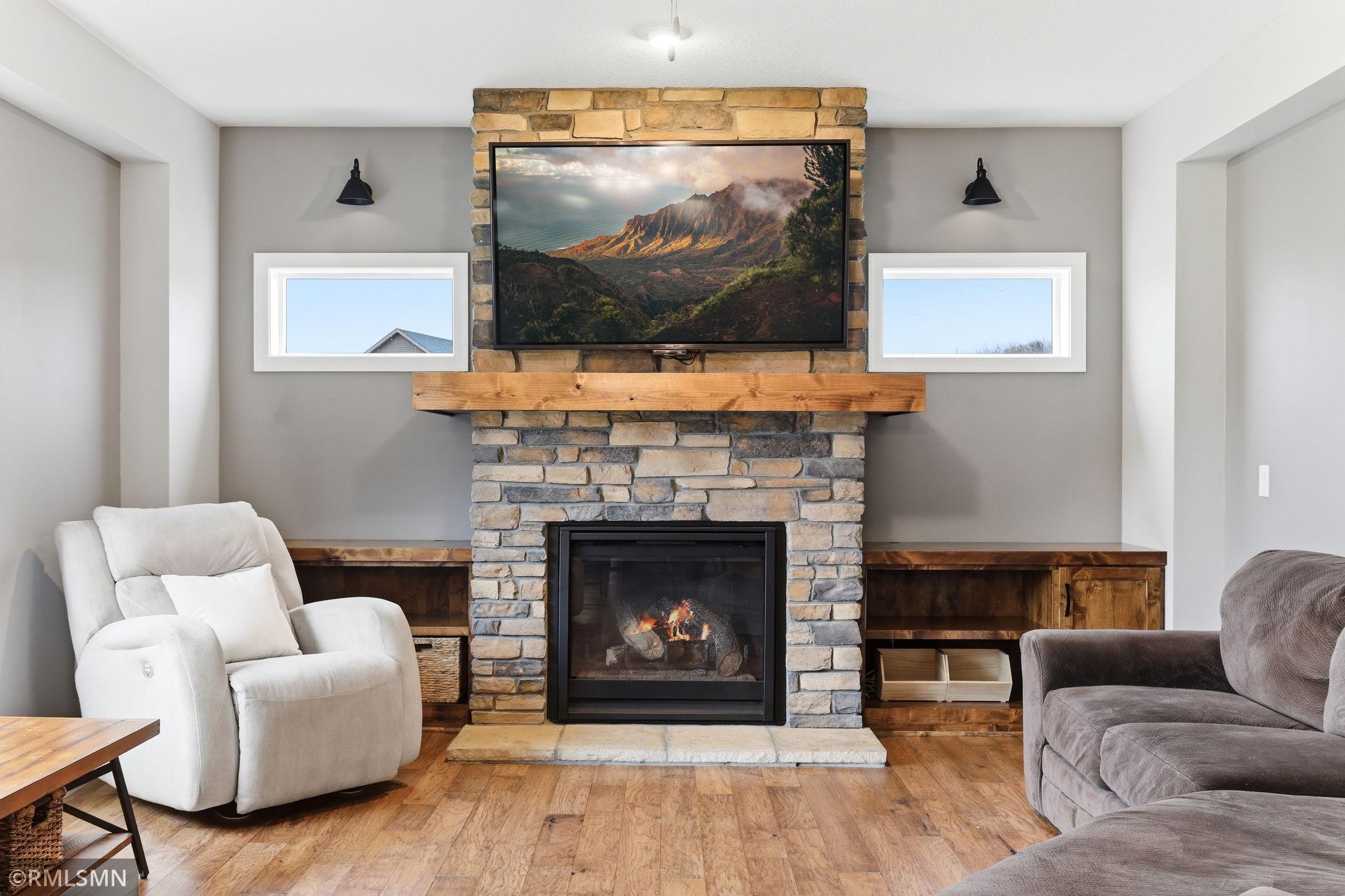 Gather around the beautiful stone fireplace and enjoy cozy evenings by the fire. Display your favorite décor and keep essentials organized with custom built-ins, all while creating a warm and inviting space to relax or entertain.