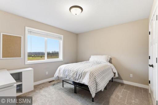 Wake up to natural light in this comfortable bedroom with soft carpet and a large window. Rest, recharge, and enjoy a peaceful space to start and end your day.
