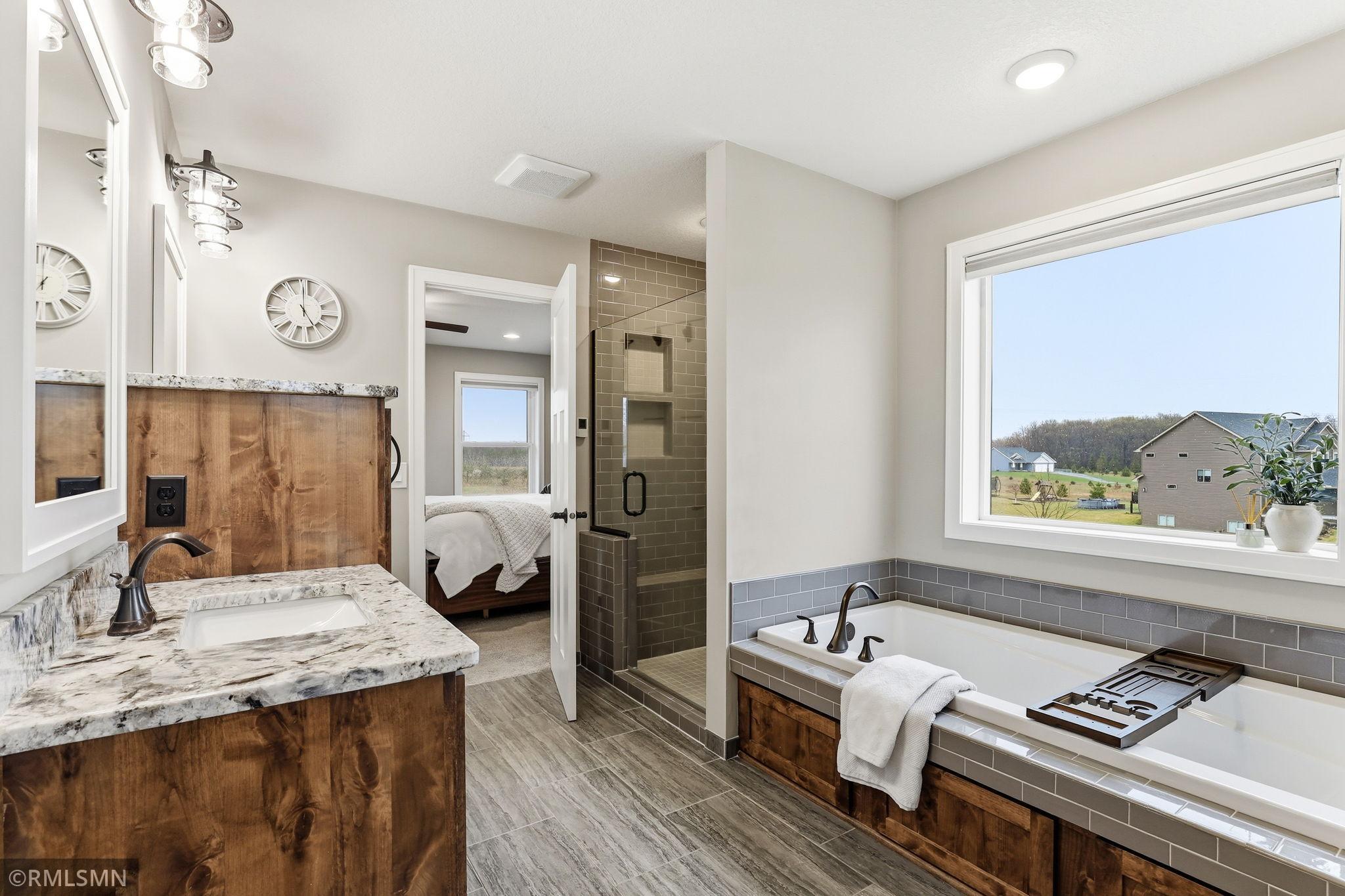 Unwind in the soaking tub, refresh in the tiled shower, and enjoy natural light that fills the space while you relax and recharge.