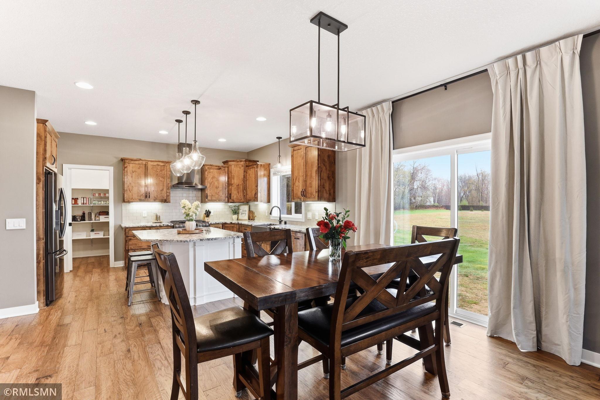 Enjoy meals with family and friends in the bright dining area, perfectly connected to the kitchen. Large windows bring in natural light and provide peaceful views, creating a warm and inviting space for everyday dining and entertaining.
