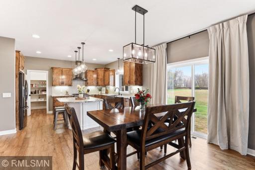 Enjoy meals with family and friends in the bright dining area, perfectly connected to the kitchen. Large windows bring in natural light and provide peaceful views, creating a warm and inviting space for everyday dining and entertaining.