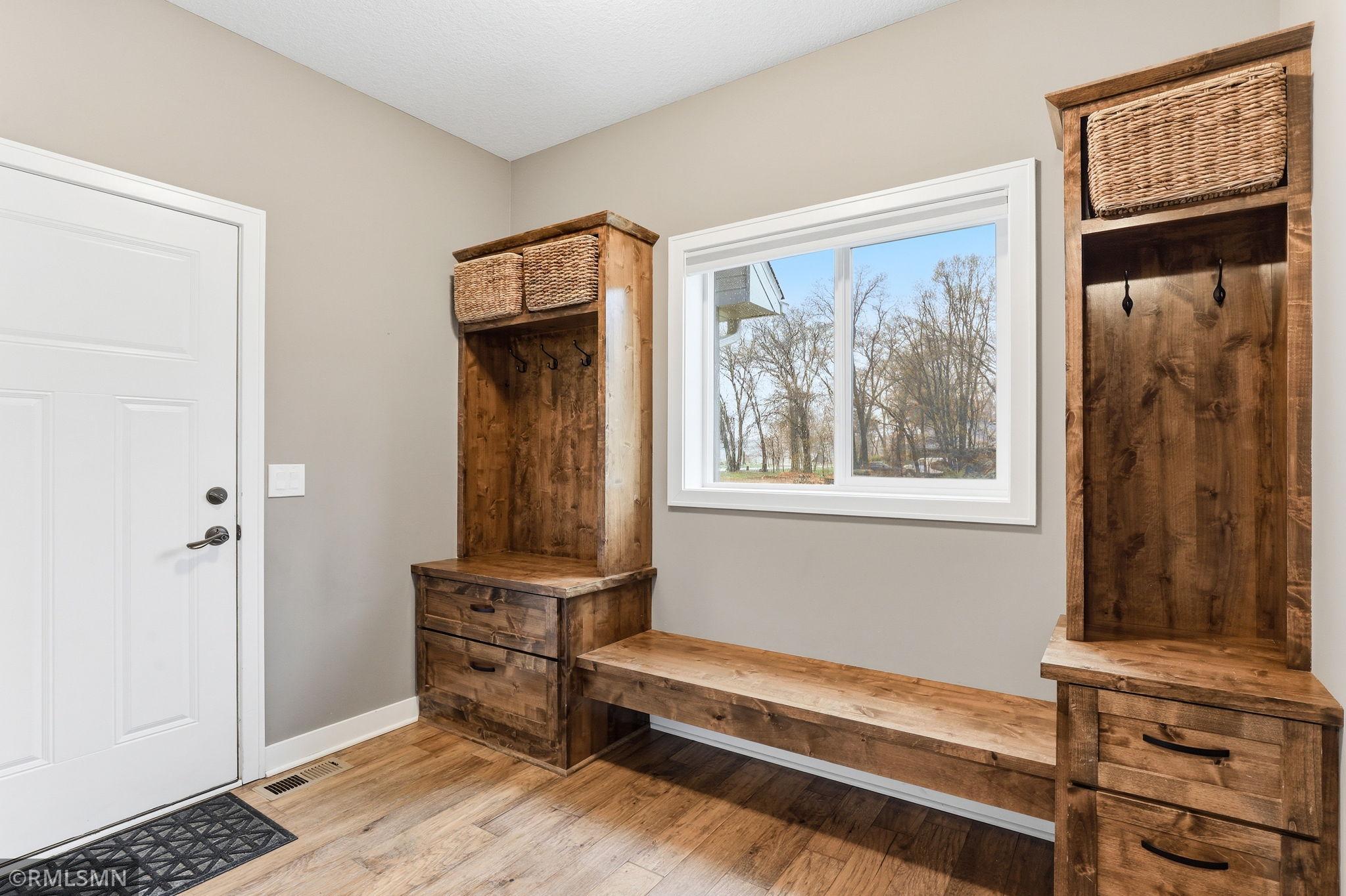 Functional mudroom just off the entry offers built-in storage, seating, and hooks to keep everything organized. Drop shoes, coats, and gear with ease and keep your home clean and clutter-free.
