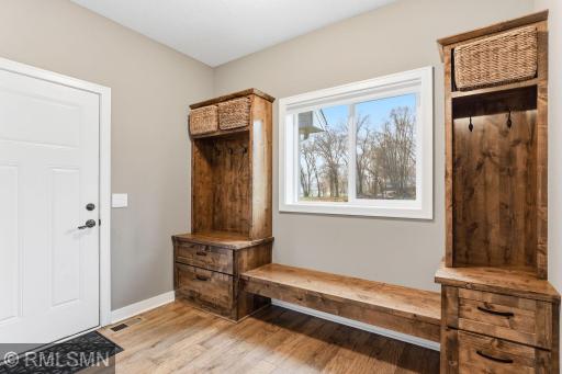 Functional mudroom just off the entry offers built-in storage, seating, and hooks to keep everything organized. Drop shoes, coats, and gear with ease and keep your home clean and clutter-free.