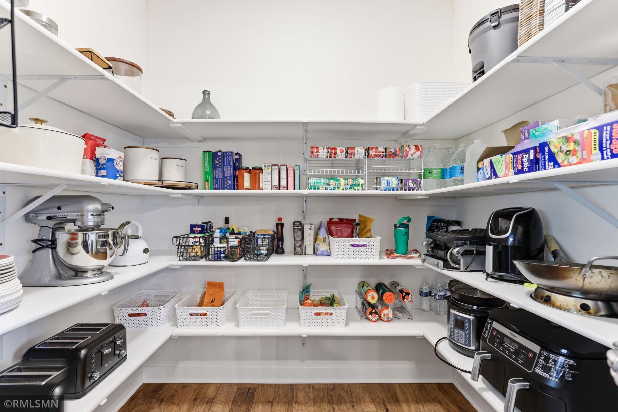 Spacious walk-in pantry just off the kitchen offers abundant shelving to keep everything organized. Store small appliances, stock up on essentials, and enjoy the convenience of having everything within easy reach.