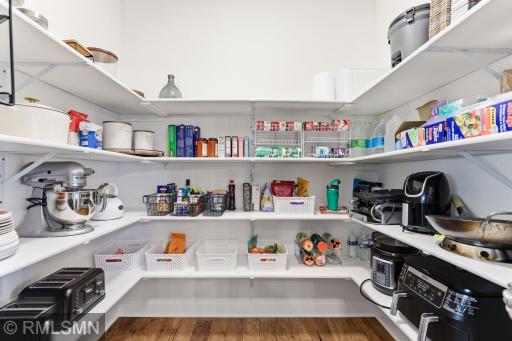 Spacious walk-in pantry just off the kitchen offers abundant shelving to keep everything organized. Store small appliances, stock up on essentials, and enjoy the convenience of having everything within easy reach.