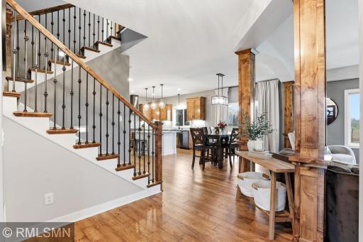 Open and inviting main level featuring rich hardwood floors, custom woodwork, and a seamless flow between the living, dining, and kitchen areas, perfect for everyday living and entertaining.