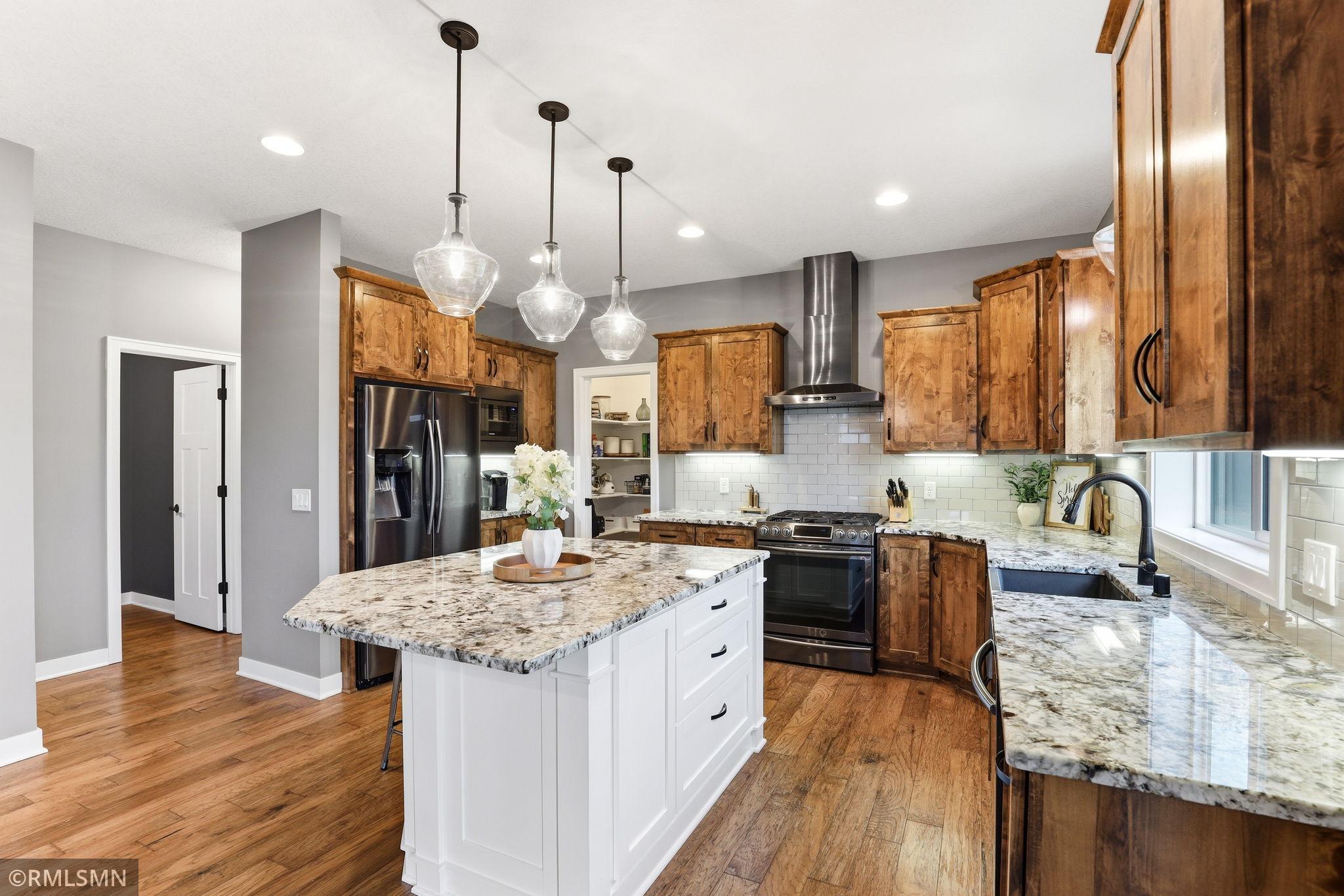 Start your day at the oversized island with space for seating, meal prep, or casual dining. Enjoy modern appliances and a layout designed for both functionality and everyday comfort.