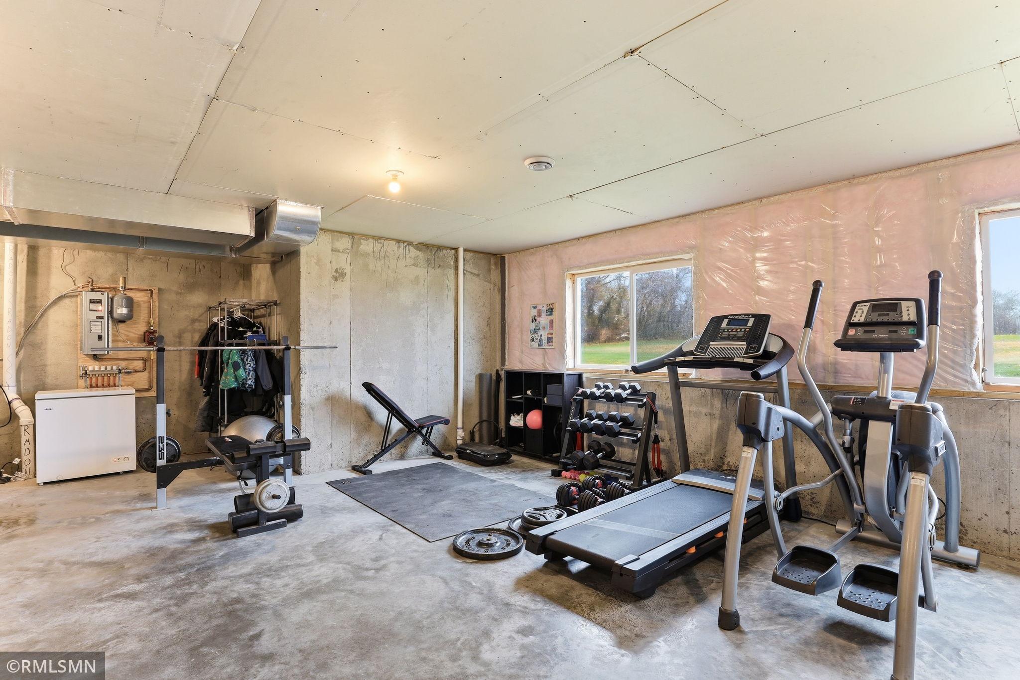 Set up your ideal home gym or recreation space in this spacious basement, featuring daylight windows that bring in natural light and make the lower level feel open and inviting.